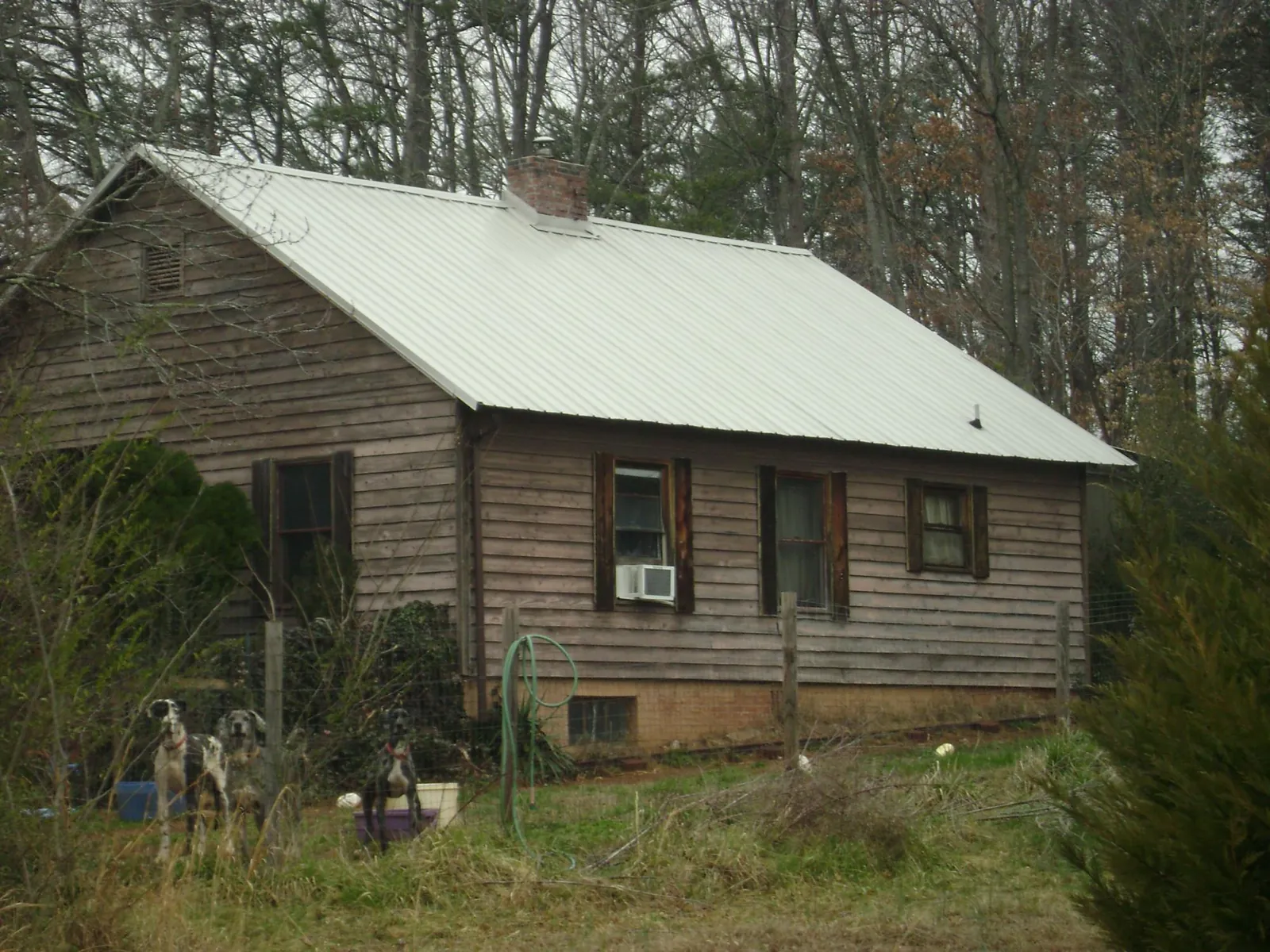 White metal roof on an old wood sided farmhouse, from a Asphalt Shingle Roof Repair job in Patterson